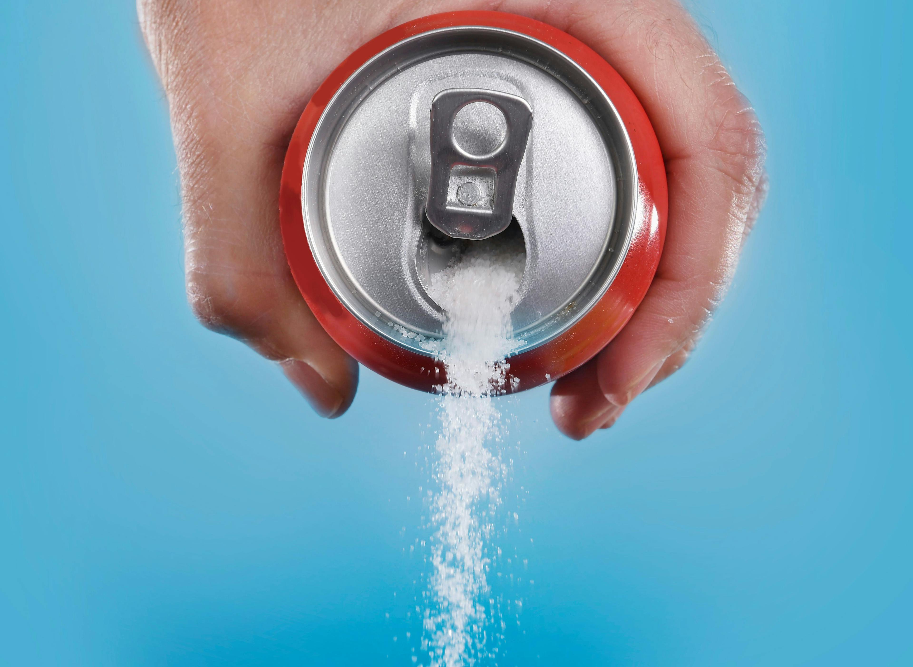 hand holding soda can pouring a crazy amount of sugar | Image Credit: Wordley Calvo Stock - stock.adobe.com
